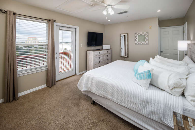 Second bedroom with TV and balcony access