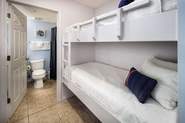 Bunk beds in hallway and full size bathroom