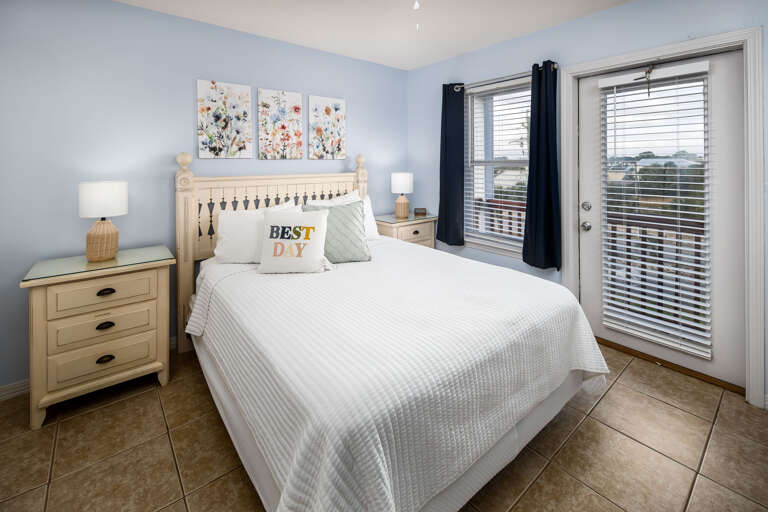 Master bedroom with king size bed and balcony access