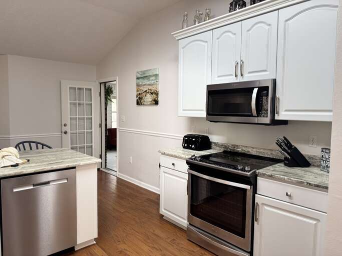 Fully stocked kitchen that opens up to sunroom