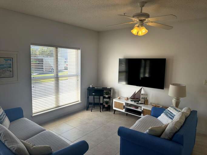 Living room with TV and outdoor views