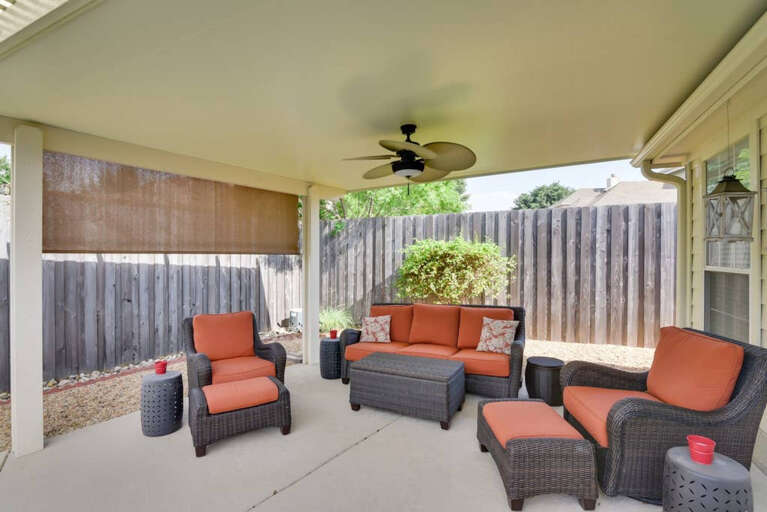 Covered Patio with Lounging chairs and Bluetooth Speakers in ceiling fan.