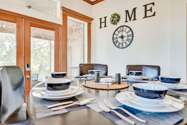 Dining room table seats up to six guests with contemporary dinnerware