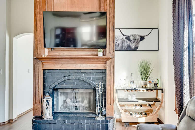 Cocktail bar in main living room, stocked with glassware and bar tools for mixing cocktails. You provide the liquor, we provide the tools to make it happen!