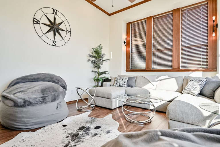 Second living area with plenty of seating for watching TV, movies, etc. Sectional sofa with two oversized beanbag chairs.