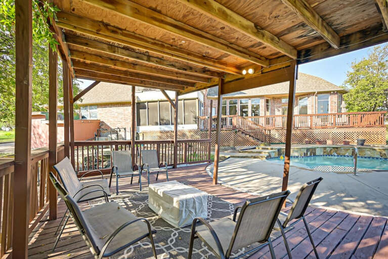 Seating area in backyard next to the pool with plenty of shade
