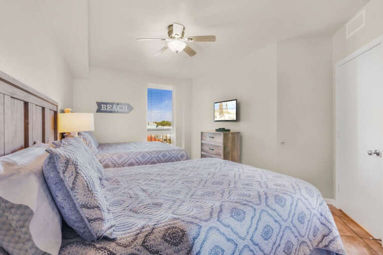 3rd bedroom with two Queen Sized beds, view out front of building and walkway 3rd bedroom with two Queen Sized beds, view out front of building and walkway
