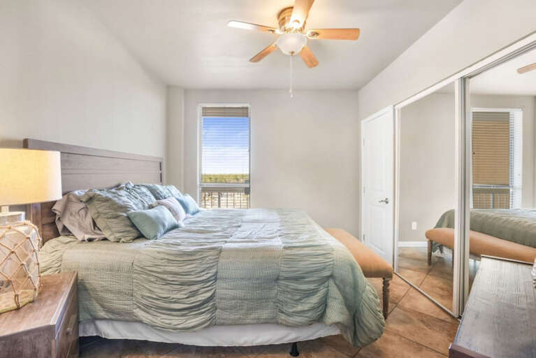 2nd bedroom with comfy King size bed, closets, view to front of building and walkway 2nd bedroom with comfy King size bed, closets, view to front of building and walkway