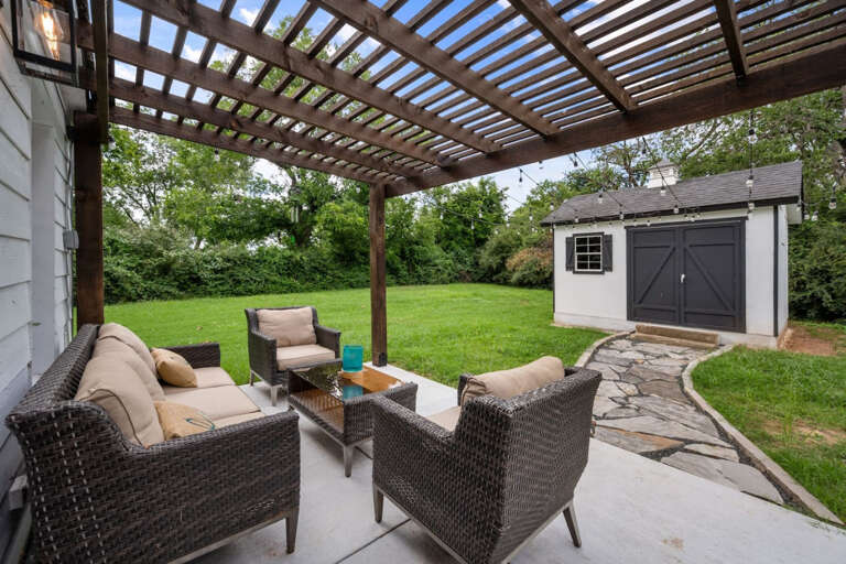 Back patio outdoor sitting area, walkway to outdoor playroom, and open outdoor play area
