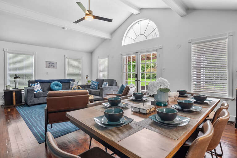 8 Seater dining room table with view toward living room seating areas and outdoor patio