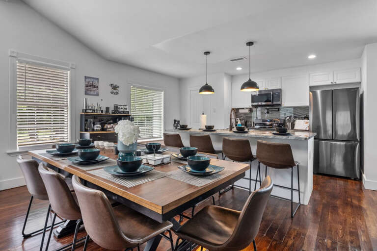 8 Seater dining room table with view to kitchen of 4 seater bar island seating and full kitchen