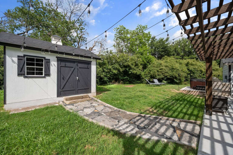 Walkway to outdoor children's playroom, view of back patio and hottub area