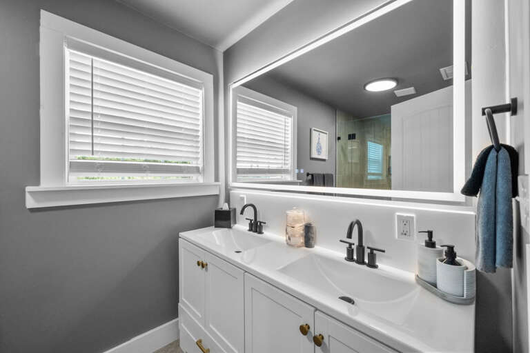 Primary En-Suite Bathroom with Dual Sinks and lighted vanity mirror.  Touch light on mirror