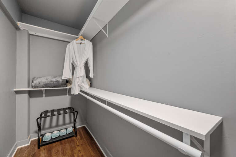Primary Bedroom closet with robes and luggage rack