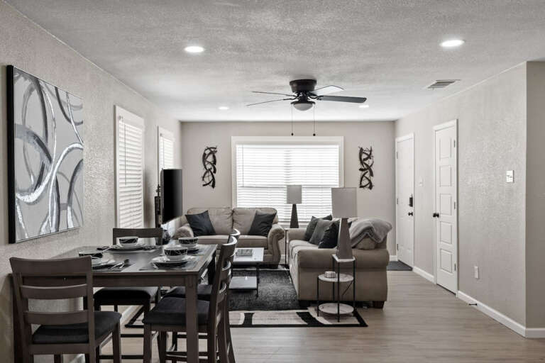 View of living room and dining space from kitchen island sitting area