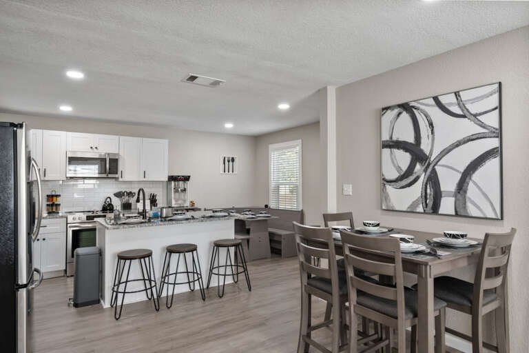 View of Dining Areas, with 4 seater high table, 6 seater corner table, and 3 seats at the island sitting area