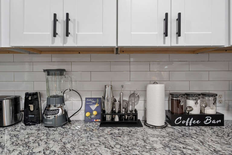 Full kitchen left countertop showing available offerings, Blender, Can opener, Toaster, Cocktalk making set, Coffee Bar with Coffee, Sugar, and Creamer, and everything you need!