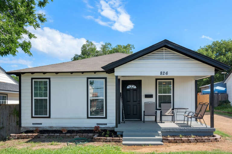 Front of property from front lawn, and front porch sitting area with 4 chairs for relaxing