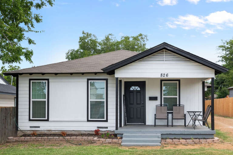 Front of property from front lawn, and front porch sitting area with 4 chairs for relaxing