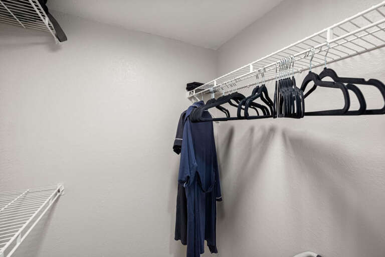 Bedroom closet with Hangers, shelves, and bath robes
