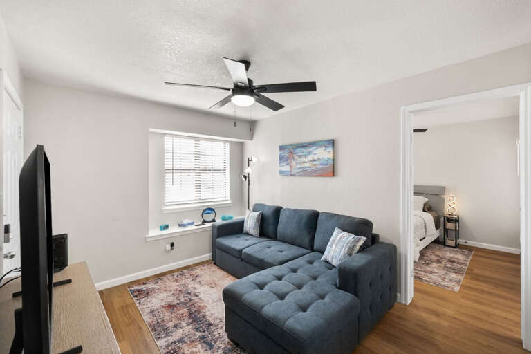 Living room with convertible full sized couch(SHOWN NOT CONVERTED-NEXT PHOTO IS CONVERTED), Samsung TV, view to bedroom