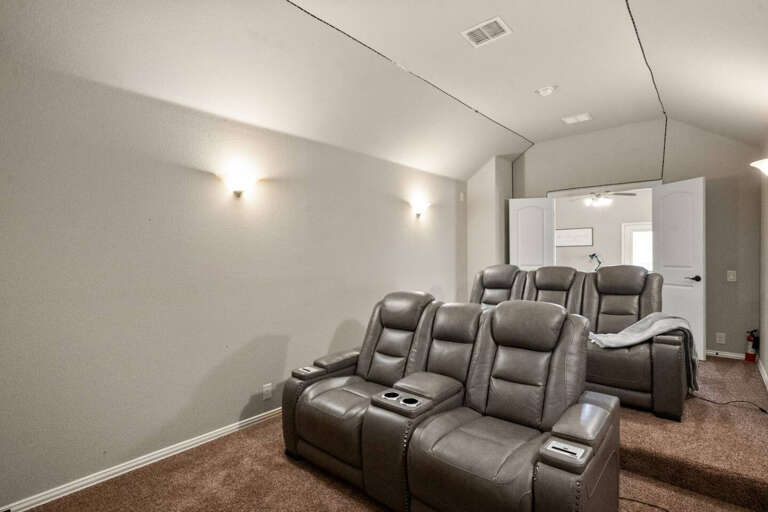 Upstairs Media room showing the 5 Extremely comfy full electric recliners that recline all the way back for your comfort, as well as TV for streaming.  Can sleep in here if you want to! Looking back toward upstairs living area.