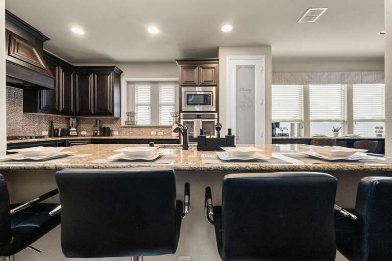 Kitchen island bar top sitting area that seats 4 looking back into kitchen.
