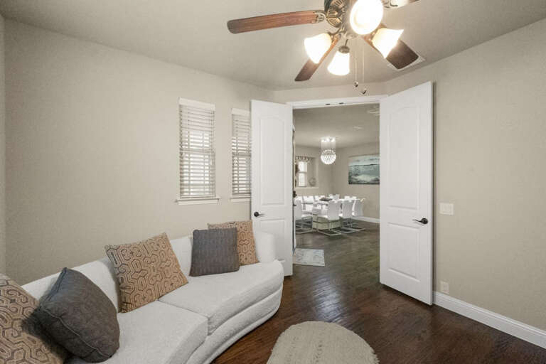 1st floor Office with lounging couch to be used as a bed, looking out to entryway and dining area.  To be used as the 5th bedroom, with a full bathroom just to right of door in this view.