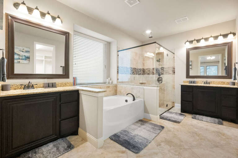 Downstairs primary bedroom, dual separate vanities, large Glass stand up shower with built in seat, and full garden tub with all you need.