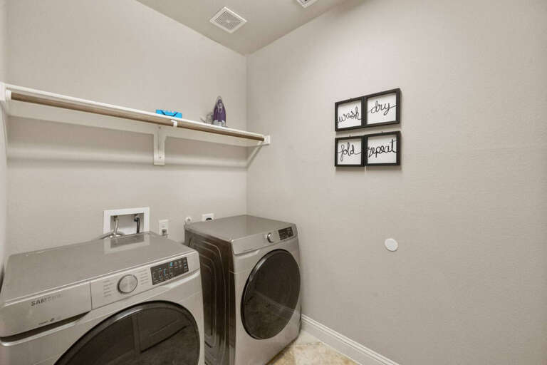 Laundry room with large front load washer and dryer