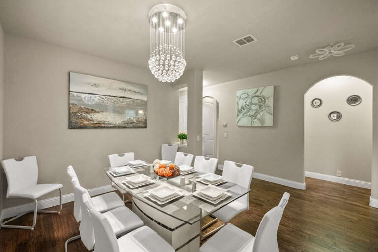 Front Dining, with seating of 6-8 people, located right after entering front door with view toward office, and hallway to laundry and garage.