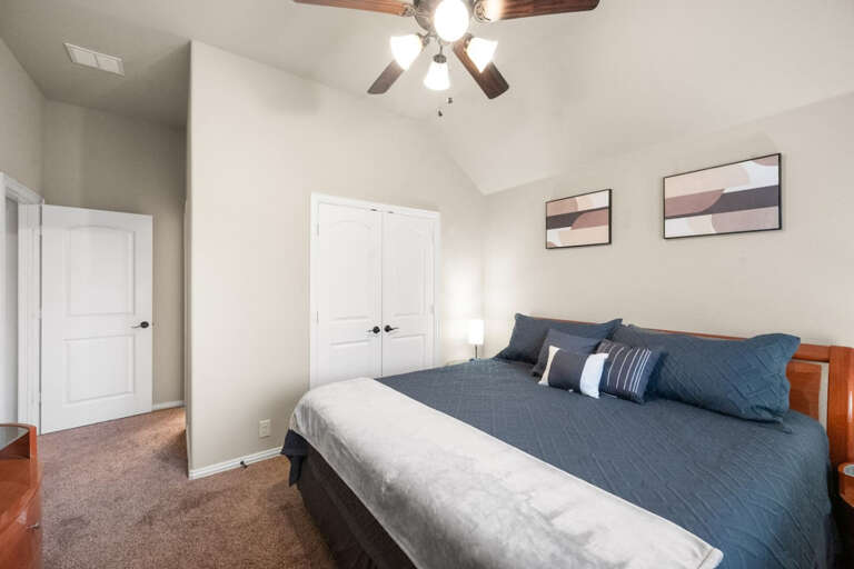 2nd Floor third back en-suite bedroom and full bathroom with King Bed, TV with streaming, nightstands and lamps on either side, and En-suite full bathroom.