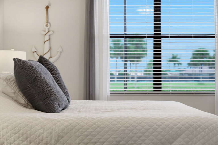 Anchor and coastal accents carry the beach theme into the primary suite.