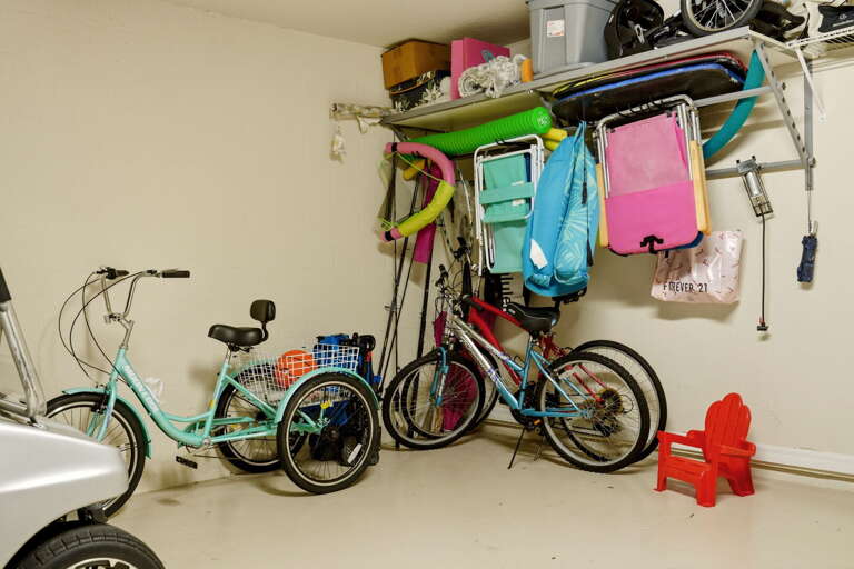 More bikes, beach chairs, and coolers round out the garage — grab what you need for a day at the pool or beach.