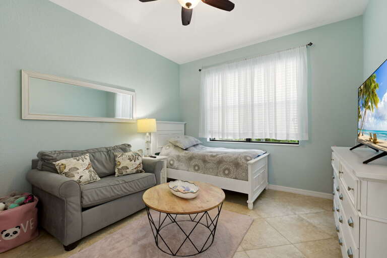 A bonus flex space off the living area — currently set up with a daybed, ideal as extra sleeping space, a playroom, or a quiet reading nook.