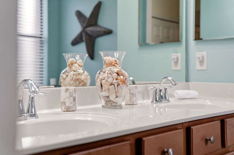 Dual sinks with playful shell and starfish styling.