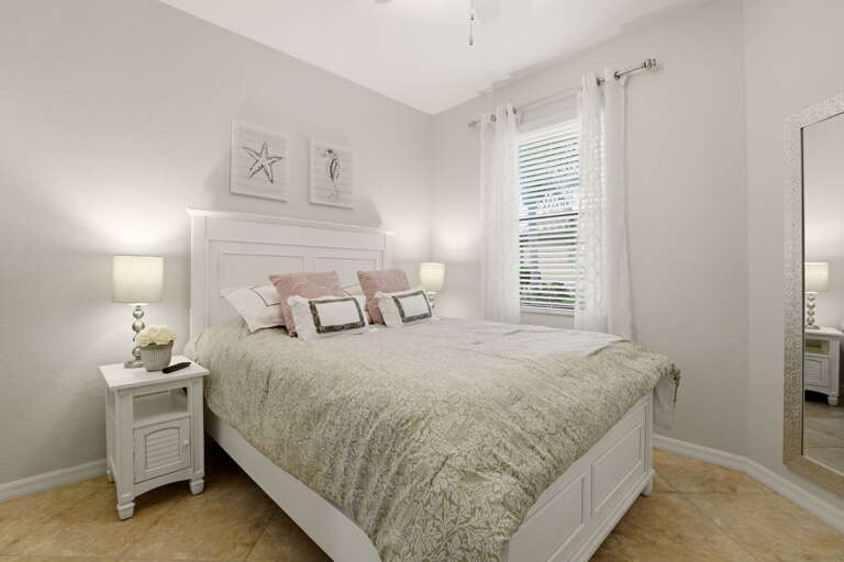 The guest bedroom offers a queen bed with its own relaxed coastal style.