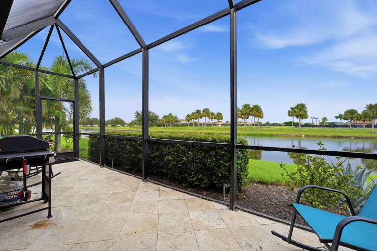Palm trees and a peaceful pond view make the lanai the best seat in the house.