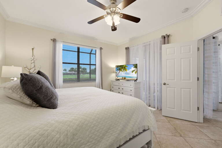 The primary bedroom features a king bed and nautical-inspired coastal decor.