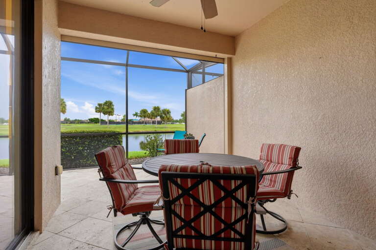 The screened lanai has its own dining table for four, overlooking the water.