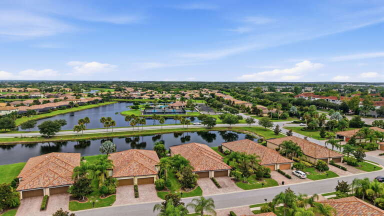 Tile roofs, palm-lined streets, and water views define the neighborhood.
