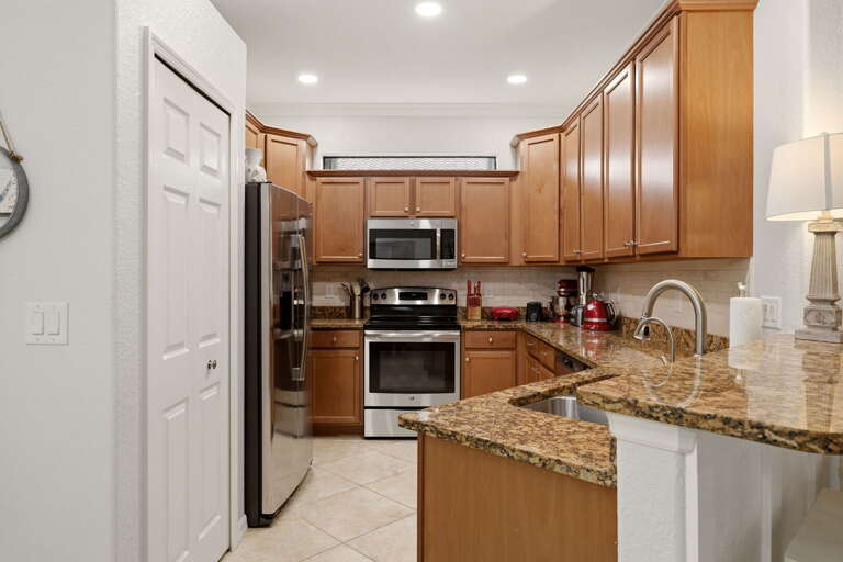 Wood cabinetry and granite counters throughout — functional and good-looking.