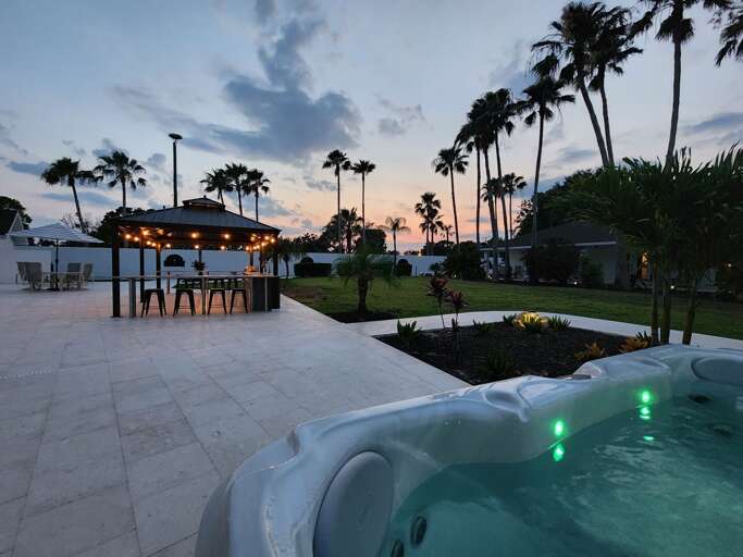 Catch the last light of the day in the hot tub — the sky goes pink and orange, the jets are running, and the outdoor kitchen is right there when you're ready to fire up the grill.