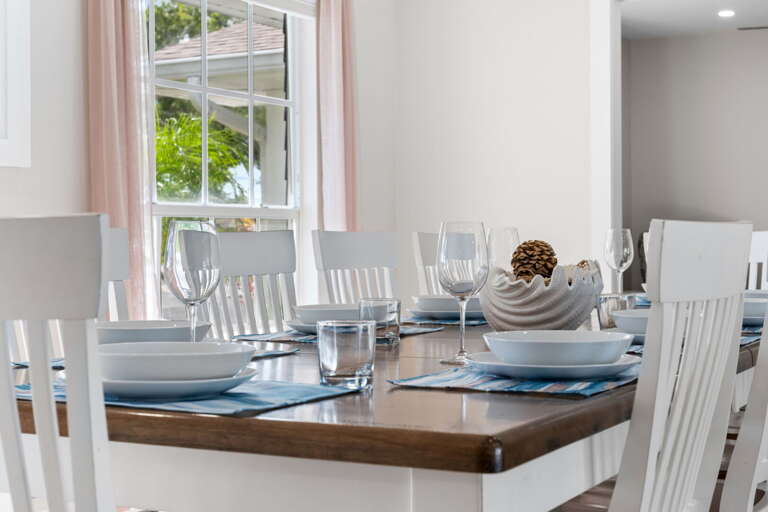 Your dining table set with plates, wine glasses, and placemats — someone went to the trouble so your first meal feels special.