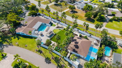 Your whole estate at a glance — two houses, pool and spa, a pickleball court, putting green, and 75 palms on one private acre.