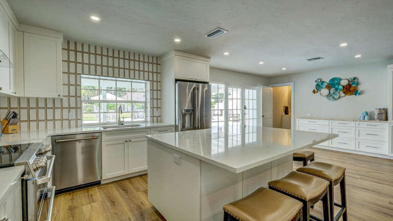 Your full-size kitchen has a dishwasher for 23 people's plates, a stainless fridge, and counter space that doesn't make cooking feel like a relay.