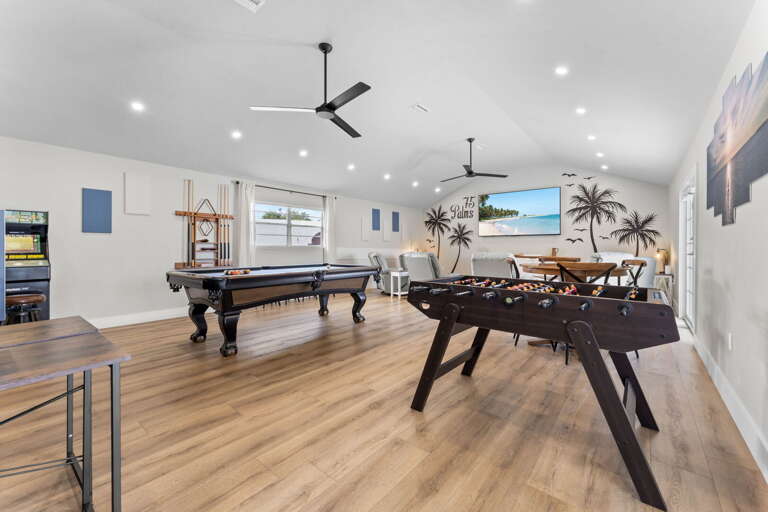 Every game your group wants is right here — pool table, foosball, and an arcade machine along the back wall. Someone's always in here at every hour of the trip.