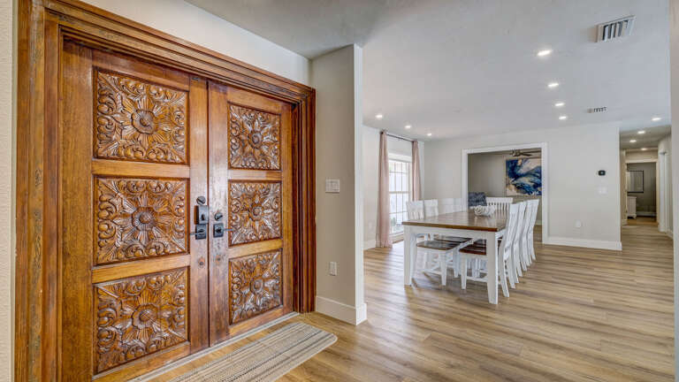 Your hand-carved wooden double doors set the tone from the first step — ornate, unique, and not what you'd expect from a rental.
