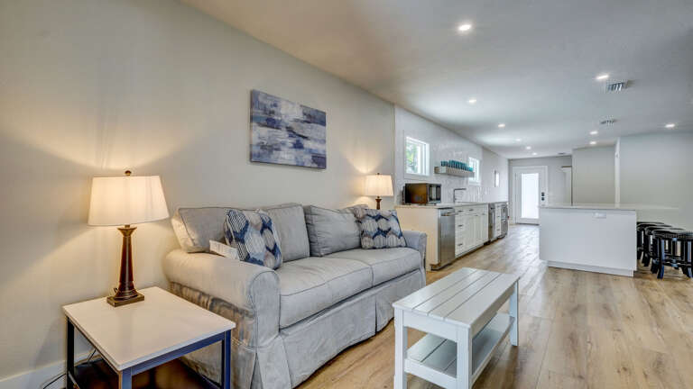 Queen sleeper sofa. Your guest house living room has its own sleeper sofa and opens right to the kitchen — whoever claims this space has their own private base camp.