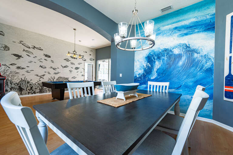 Gather around a table that seats everyone — the ocean-inspired dining room sets the mood before the first bite